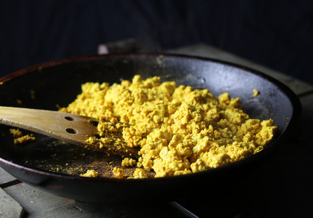 2. Fry the vegan scrambled eggs in the pan until well cooked.