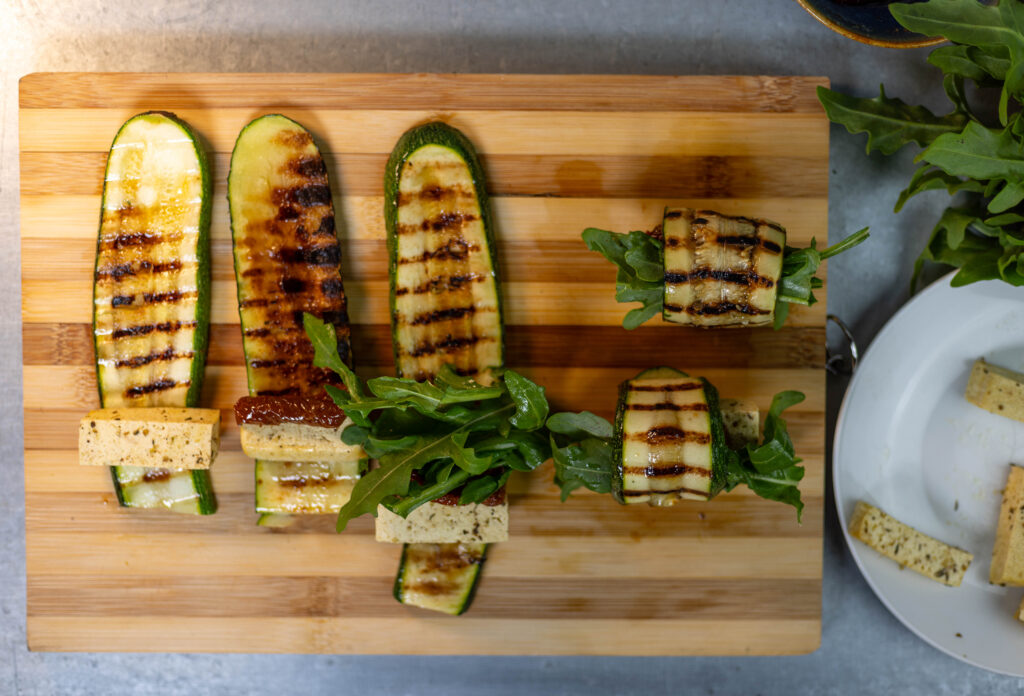 5. Die Füllung in die Zucchinistreifen einrollen. Fertig sind die gegrillten Zucchiniröllchen.