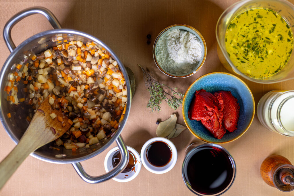 3. Zwiebel, Möhre, Knollensellerie und Champignons werden scharf angebraten.