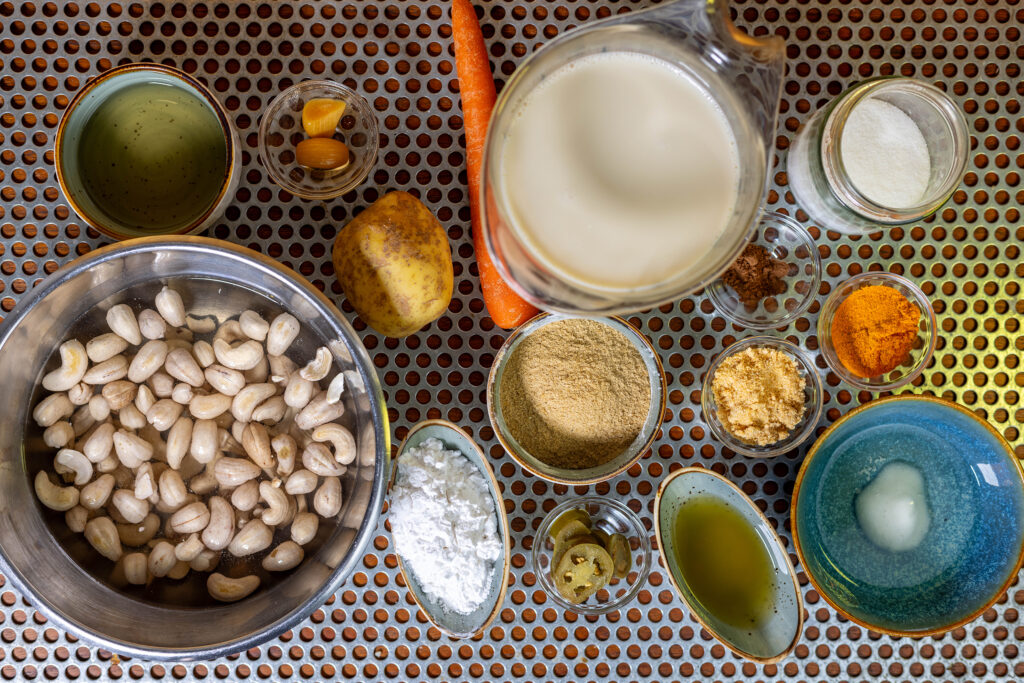 All ingredients for the vegan cheese dip. The cashews are soaked. The carrot and potato must be cooked until soft.