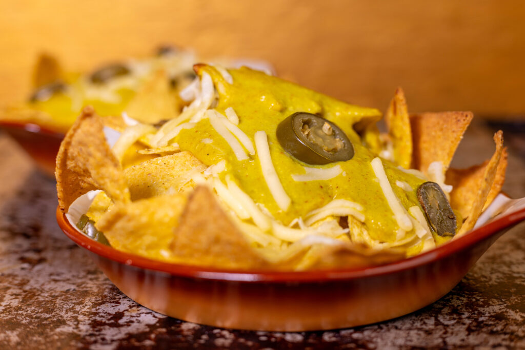 A bowl of nachos with vegan cheese dip by Daily Vegan's Sean Moxie. A real treat for cheese lovers.