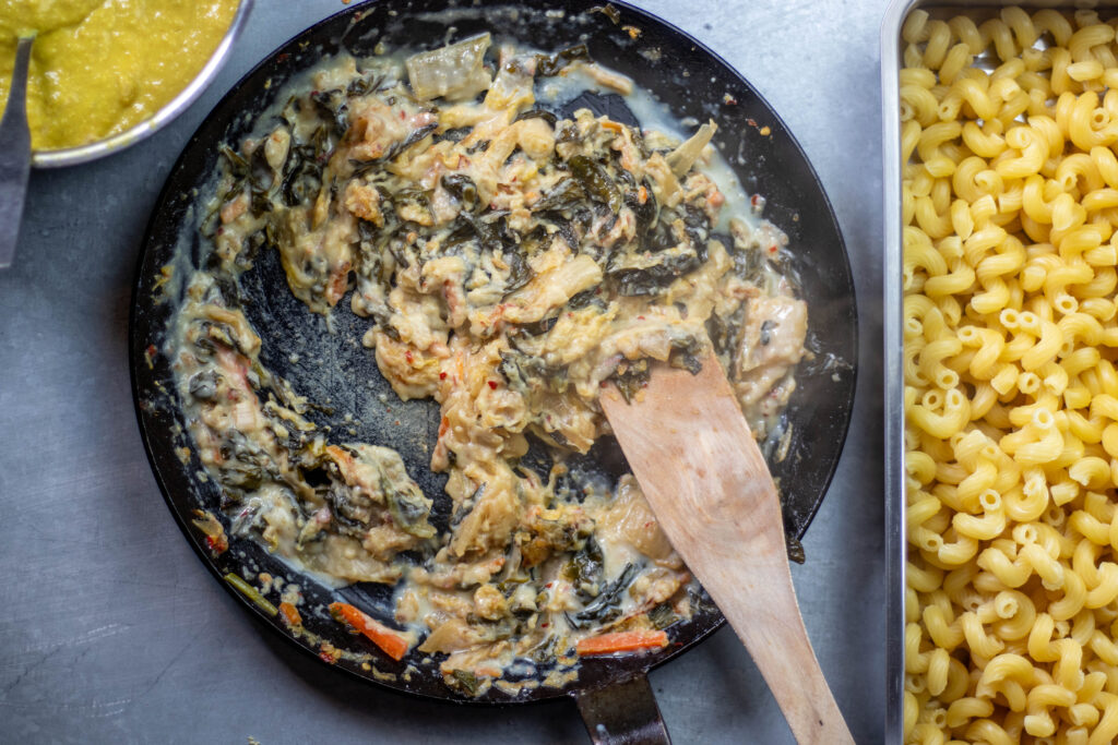 Vegan kimchi and more ingredients frying in a pan.