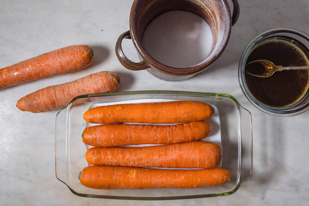 Wet carrots on a salt bed.