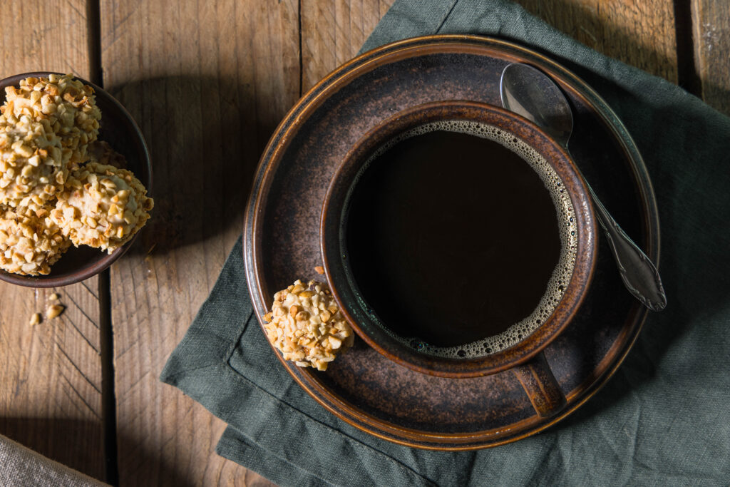 Viotto – homemade vegan Giotto – in a bowl. Next to it is a cup of coffee, with another Giotto on the saucer.